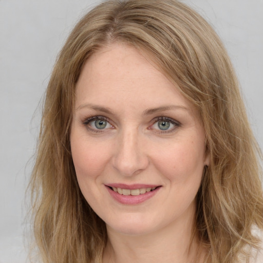 Joyful white young-adult female with long  brown hair and green eyes