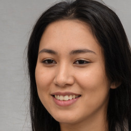 Joyful asian young-adult female with long  brown hair and brown eyes