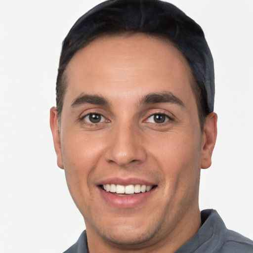 Joyful white young-adult male with short  black hair and brown eyes