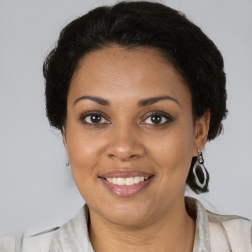 Joyful black young-adult female with medium  brown hair and brown eyes