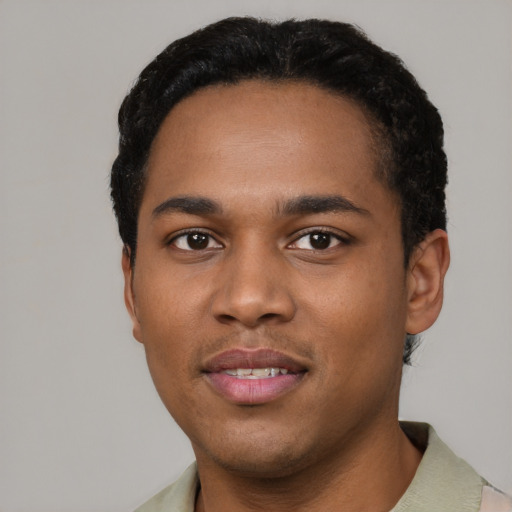 Joyful black young-adult male with short  black hair and brown eyes