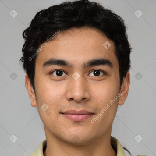 Joyful latino young-adult male with short  brown hair and brown eyes