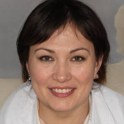 Joyful white adult female with medium  brown hair and brown eyes