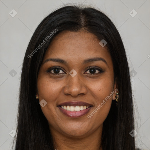 Joyful black young-adult female with long  brown hair and brown eyes