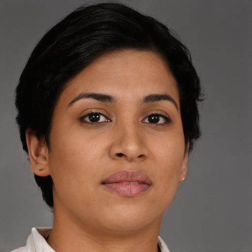 Joyful latino young-adult female with short  brown hair and brown eyes