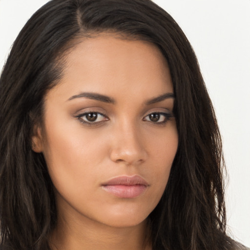 Joyful latino young-adult female with long  brown hair and brown eyes