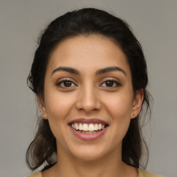 Joyful latino young-adult female with medium  brown hair and brown eyes