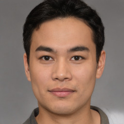 Joyful asian young-adult male with short  brown hair and brown eyes