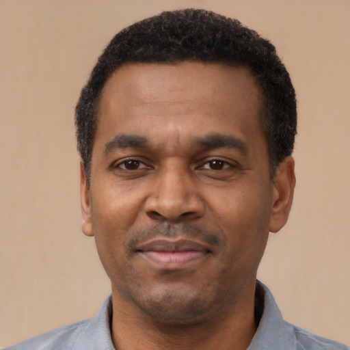 Joyful latino adult male with short  black hair and brown eyes
