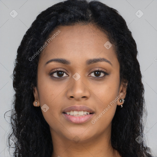 Joyful black young-adult female with long  black hair and brown eyes