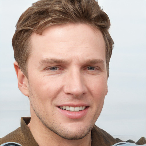 Joyful white adult male with short  brown hair and grey eyes