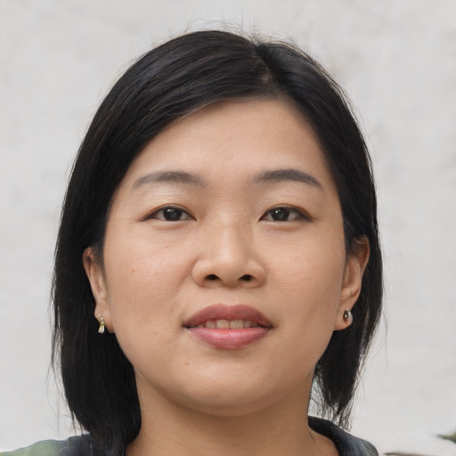 Joyful asian young-adult female with medium  black hair and brown eyes