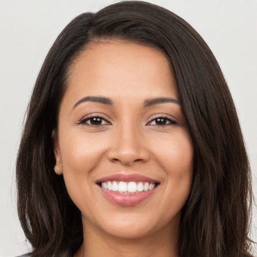 Joyful white young-adult female with long  brown hair and brown eyes