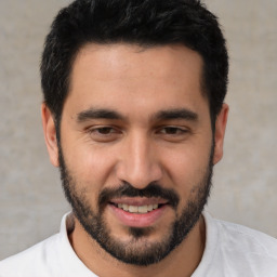 Joyful white young-adult male with short  black hair and brown eyes