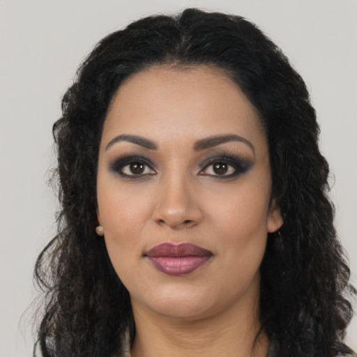 Joyful latino young-adult female with long  black hair and brown eyes