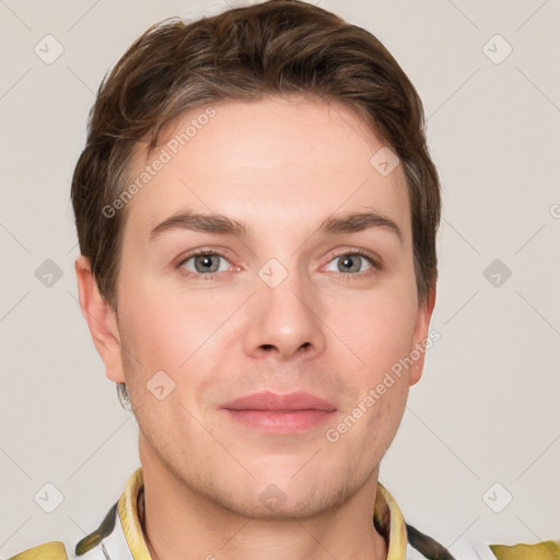 Joyful white young-adult male with short  brown hair and grey eyes