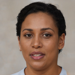 Joyful latino adult female with short  brown hair and brown eyes