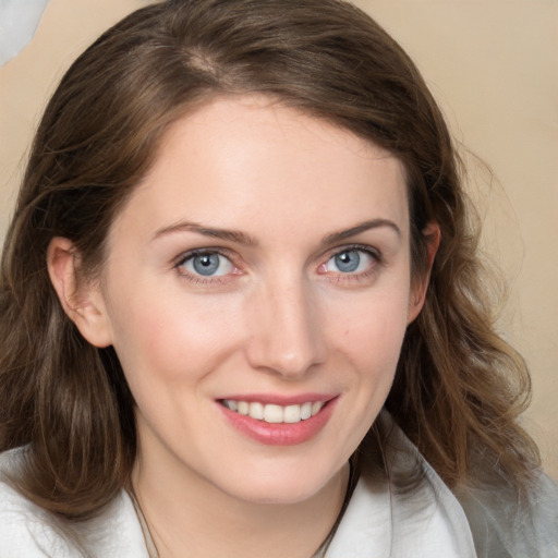 Joyful white young-adult female with medium  brown hair and blue eyes