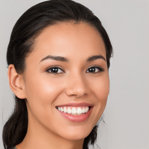 Joyful latino young-adult female with medium  brown hair and brown eyes