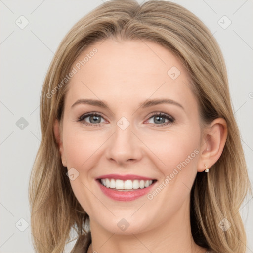 Joyful white young-adult female with long  brown hair and blue eyes