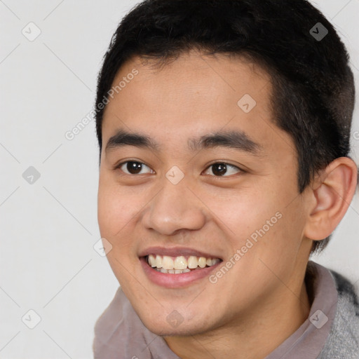 Joyful latino young-adult male with short  brown hair and brown eyes