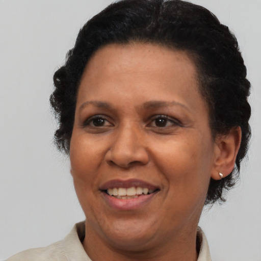 Joyful black adult female with short  brown hair and brown eyes