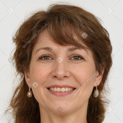 Joyful white adult female with long  brown hair and green eyes