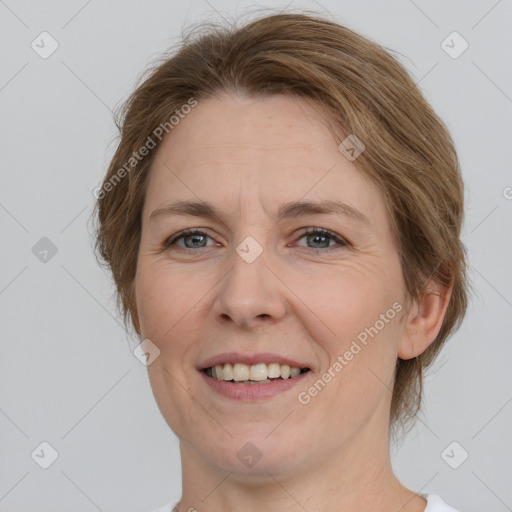 Joyful white adult female with medium  brown hair and grey eyes