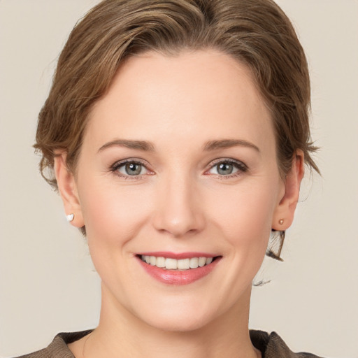 Joyful white young-adult female with medium  brown hair and grey eyes