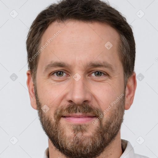 Joyful white adult male with short  brown hair and brown eyes