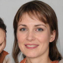 Joyful white young-adult female with medium  brown hair and blue eyes