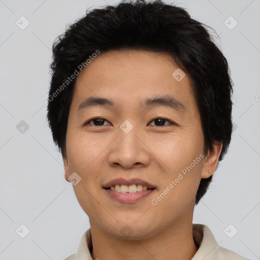 Joyful asian young-adult male with short  brown hair and brown eyes