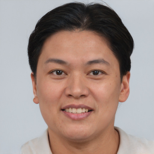 Joyful asian young-adult female with short  brown hair and brown eyes