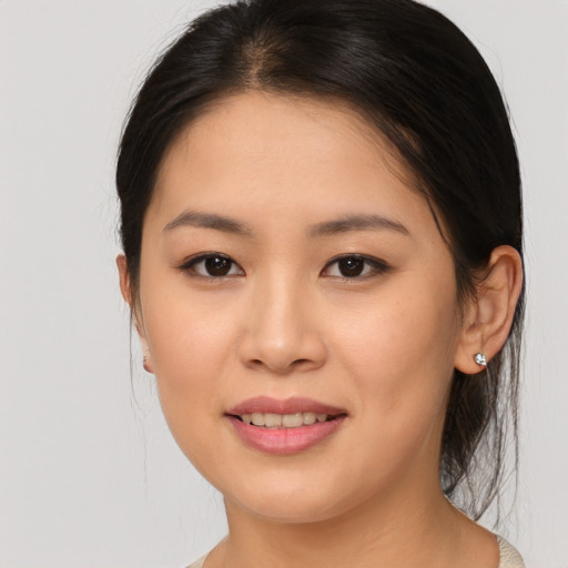 Joyful asian young-adult female with medium  brown hair and brown eyes