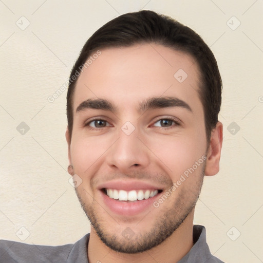 Joyful white young-adult male with short  black hair and brown eyes