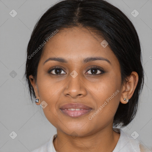 Joyful black young-adult female with medium  brown hair and brown eyes