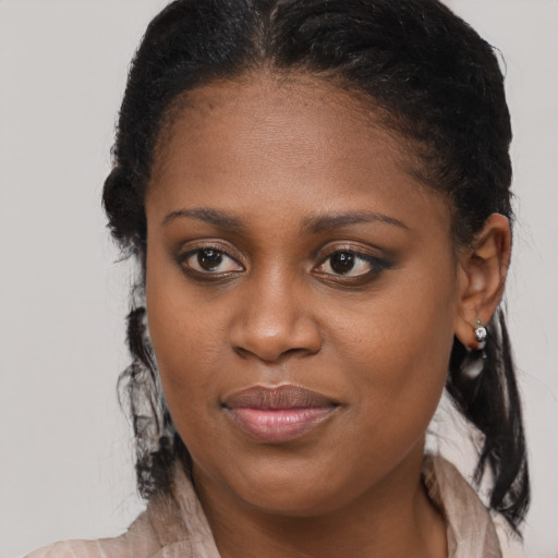 Joyful black young-adult female with medium  brown hair and brown eyes