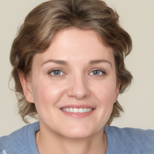 Joyful white young-adult female with medium  brown hair and blue eyes