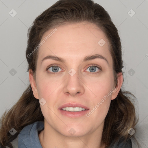 Joyful white young-adult female with long  brown hair and blue eyes