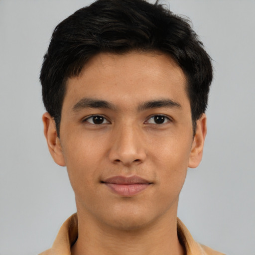 Joyful latino young-adult male with short  brown hair and brown eyes