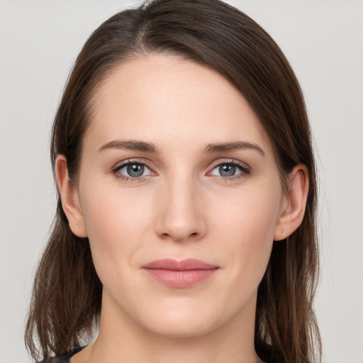 Joyful white young-adult female with long  brown hair and grey eyes