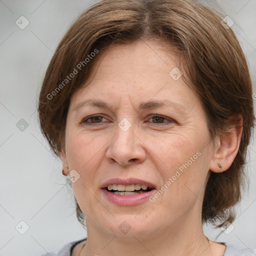 Joyful white adult female with medium  brown hair and grey eyes