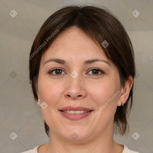 Joyful white adult female with medium  brown hair and brown eyes