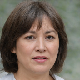 Joyful white adult female with medium  brown hair and brown eyes