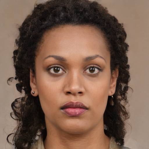 Neutral black young-adult female with medium  brown hair and brown eyes