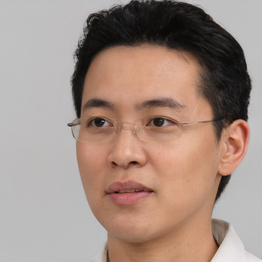 Neutral asian adult male with short  black hair and brown eyes