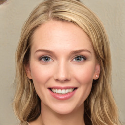 Joyful white young-adult female with long  brown hair and blue eyes