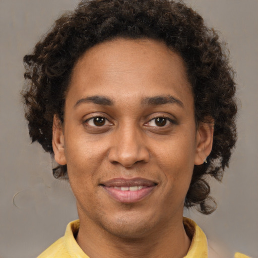 Joyful black young-adult female with short  brown hair and brown eyes