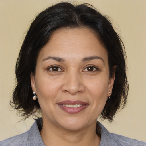 Joyful white adult female with medium  brown hair and brown eyes