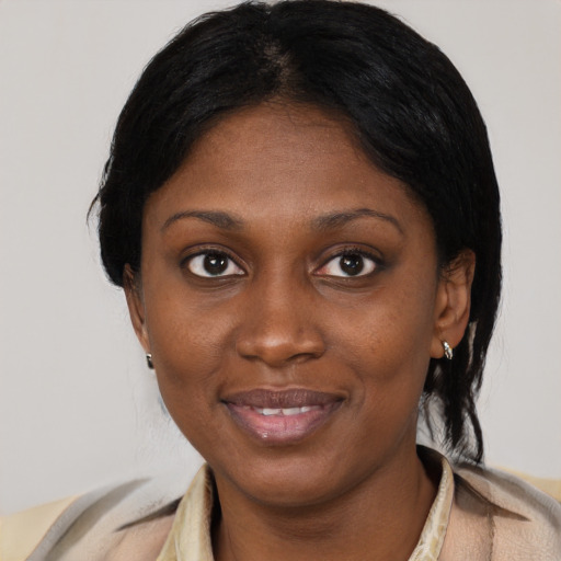 Joyful black young-adult female with short  black hair and brown eyes